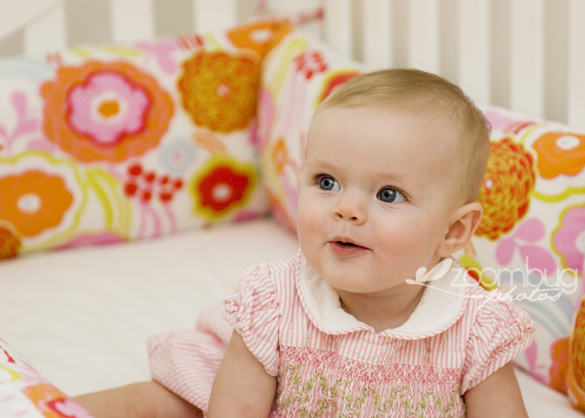 baby girl in colorful baby bedding